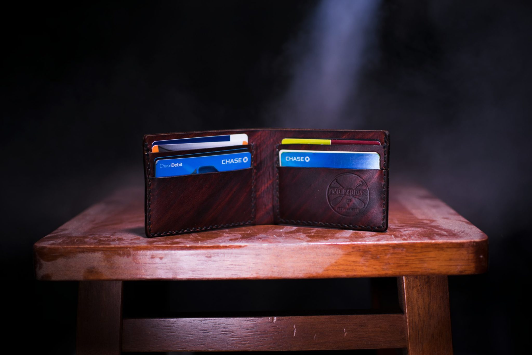 Wallet full of credit cards sitting on a table open standing up.