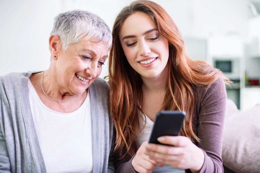 picture of daughter looking at phone app with mother